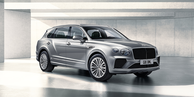 Bentley Panama Bentley Bentayga Extended Wheelbase SUV front three quarter in Moonbeam paint with a grey background