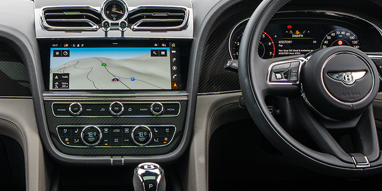 Bentley Panama Bentley Bentayga S SUV front interior with right hand drive steering wheel and centre console with MMI screen showing driving directions